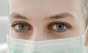 Close-up of a woman’s face and eyes. She is wearing a mask.
