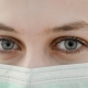 Close-up of a woman’s face and eyes. She is wearing a mask.